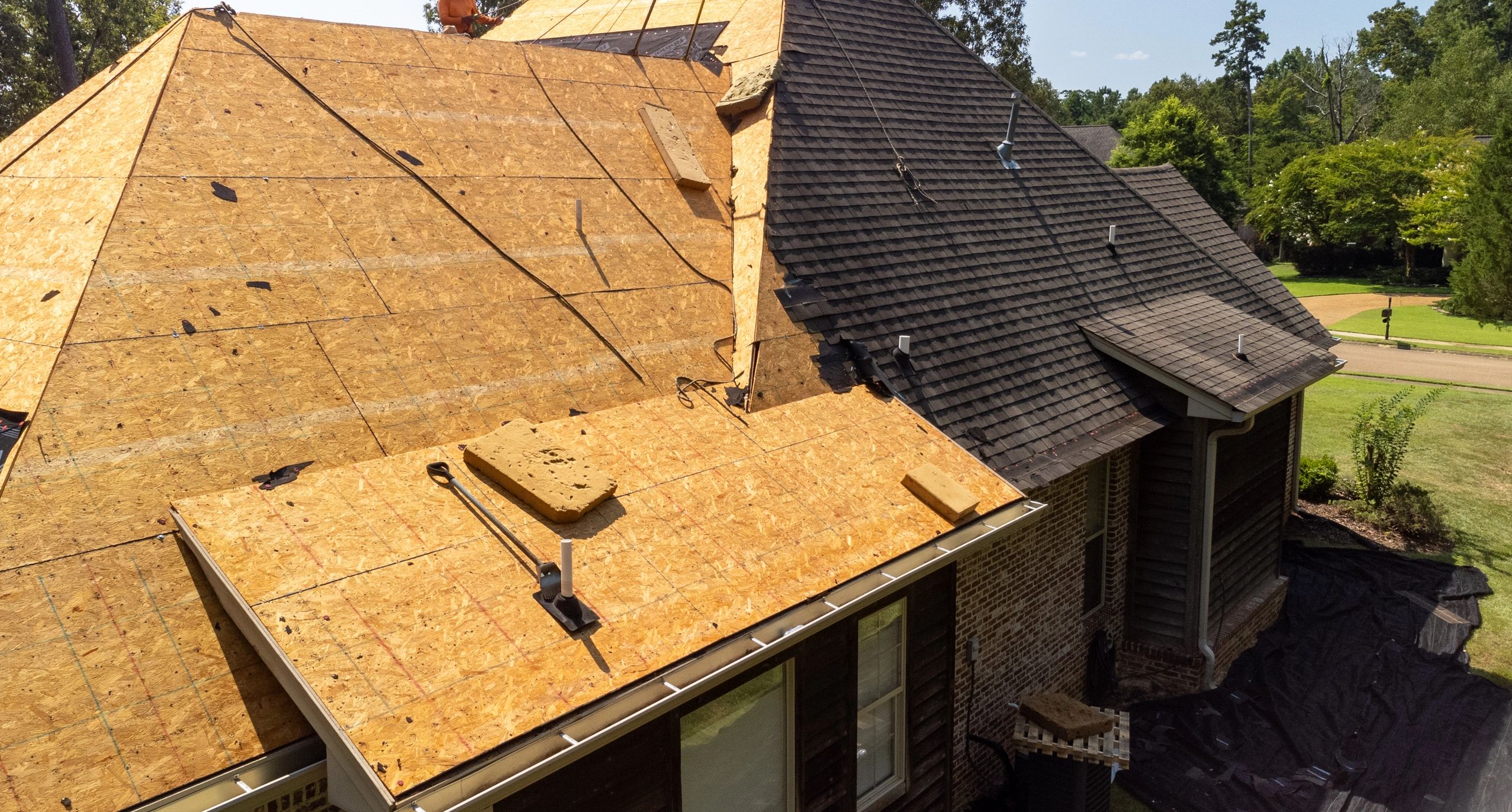 Roof replacement in progress with workers